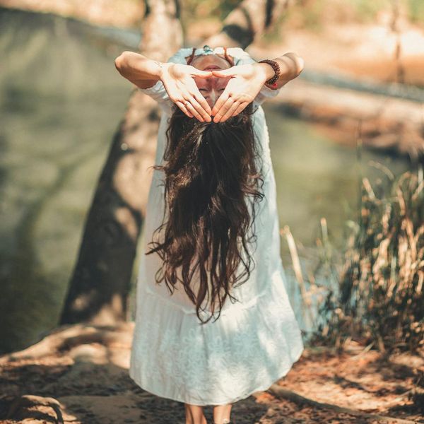 Person meditating peacefully in a calm, serene environment.